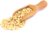 Image of a wooden scoop full of Pine nuts