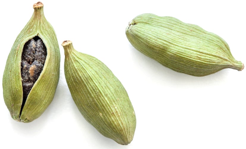 Three Cardamom Seed pods on white background
