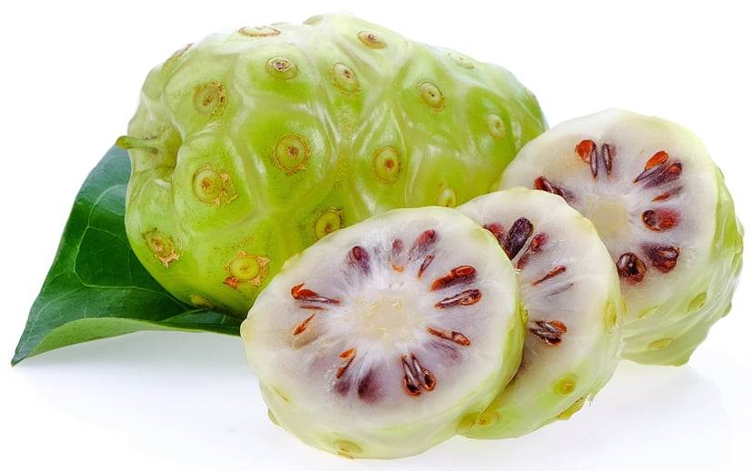 Image of a whole fresh noni fruit and some noni fruit slices
