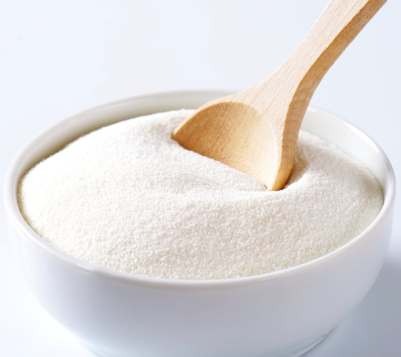 Whole Milk Powder win white bowl with wooden spoon