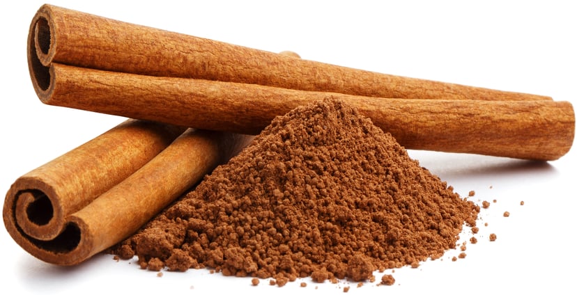 Image of 2 cinnamon sticks next to cinnamon powder