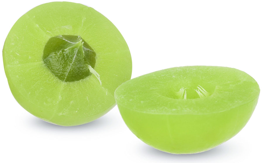 Image of a fresh green Amla fruit cut in half