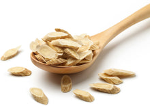 Image of a wooden spoon full of astragalus root pieces.