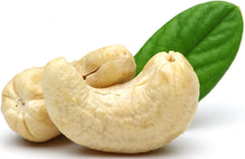 Image of 2 whole cashews and a green leaf