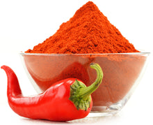 Cayenne Pepper Powder  in glass bowl and 1 pepper laying on white background