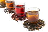 Image of different colored teas in clear glasses