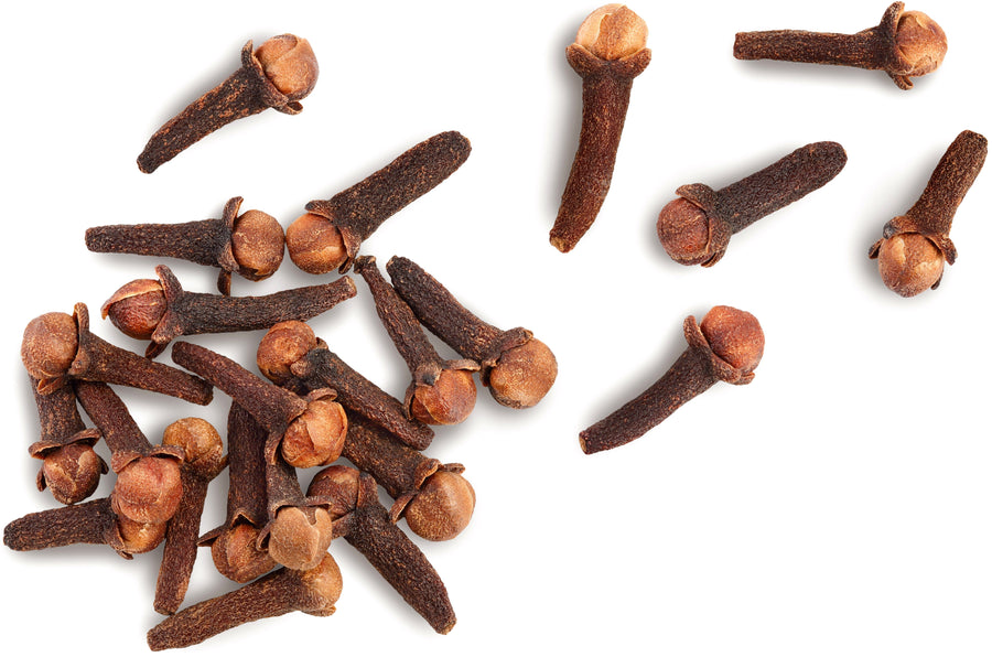 Cloves piled together on white background