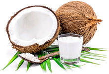 Image of a half coconut with bright white flesh and coconut milk in a cup