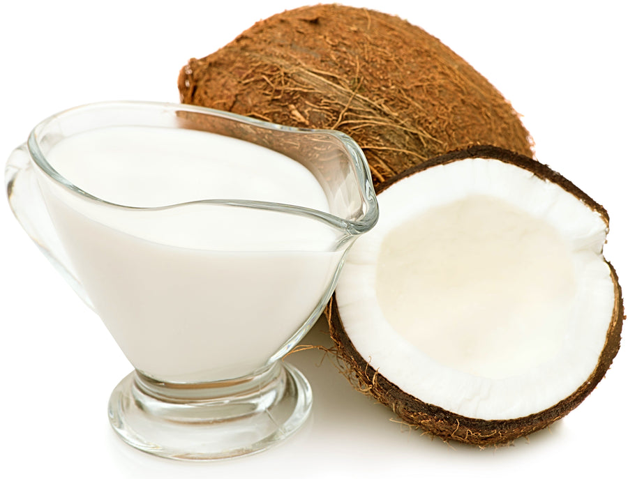 Image of half a coconut and coconut milk in a cup