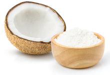 Image of half a coconut and coconut milk powder in a wood bowl next to it