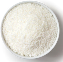 Overhead image of a bowl of Shredded coconut on white background.