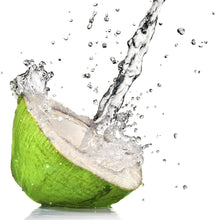 Image of Coconut water splashing from a green coconut on white background