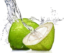 Image of coconut water splashing inside a half a coconut and a whole coconut
