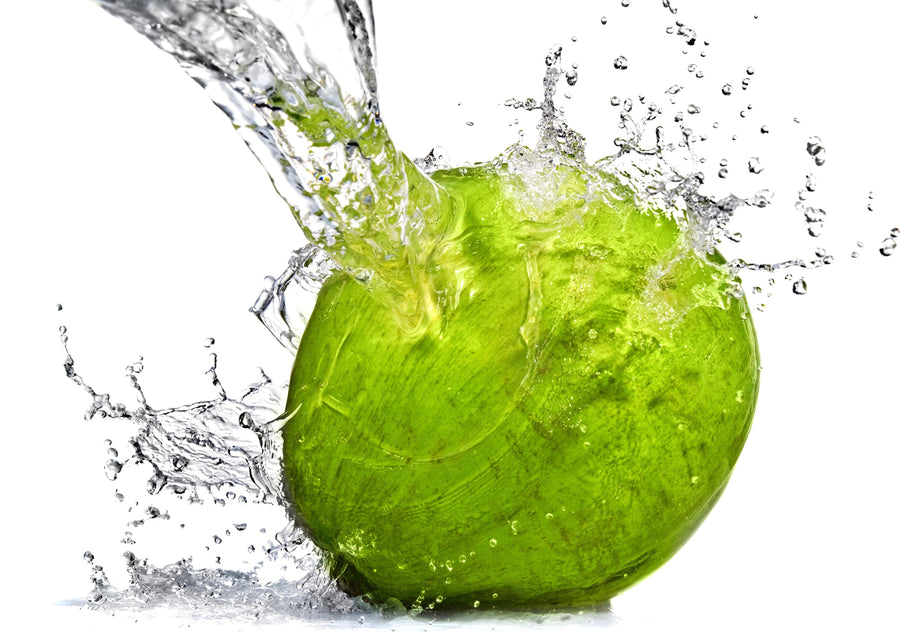 Image of Coconut Water splashing on a green coconut