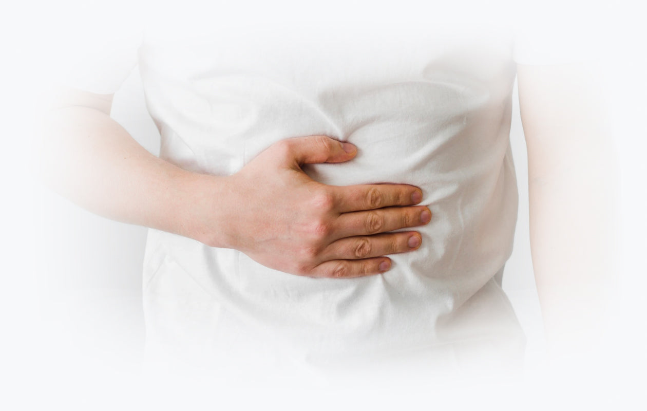 Image depicting person holding stomach because of colic pain