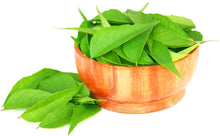 Image of green Curry Leaves inside and next to a brown bowl