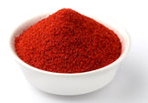 Image of a white bowl full of bright red Essential Reds powder