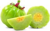 Image of a green Garcinia Cambogia fruit and some slices