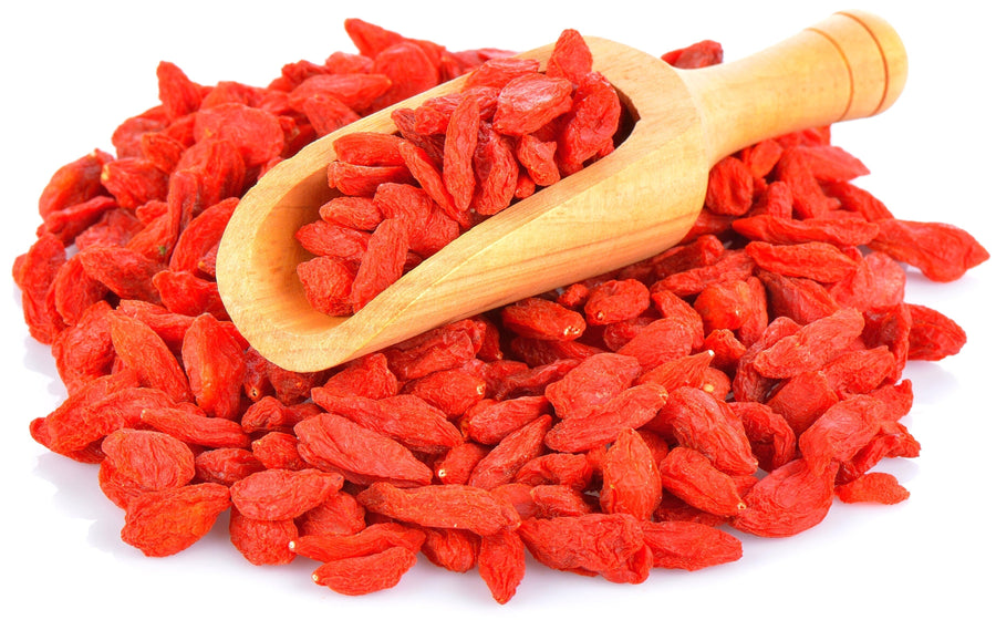 Image of sun-dried Goji Berries with wooden scoop on a white background
