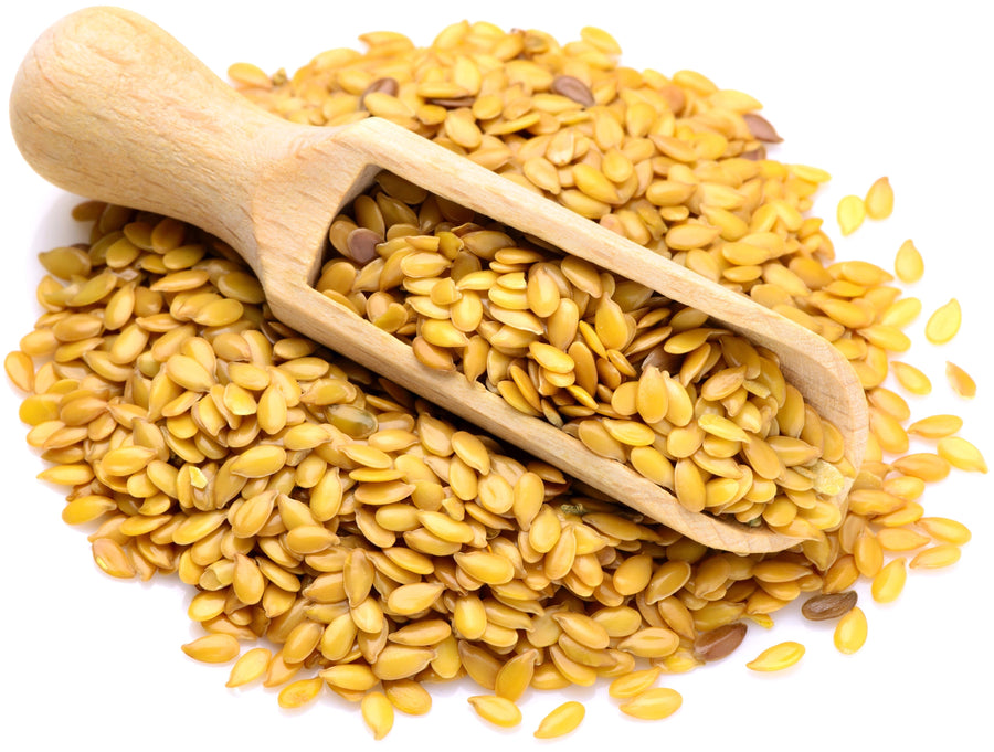 Image of Golden Flax Seeds with wooden serving scoop on top.