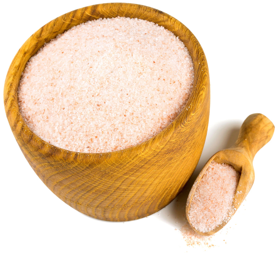Image of himalayan pink salt fine grain in a wooden bowl with a wooden spoon