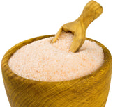 Image of himalayan pink salt fine grain in a wooden bowl with a wooden spoon