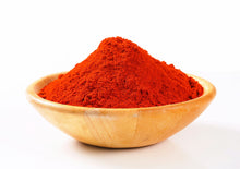 Image of heaping Ground Paprika in wooden bowl on white back ground.