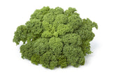 Overhead image of bunches of Kale next to each other on white background.
