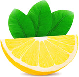 Image of quartered Lemon Juice with leaves in the background.