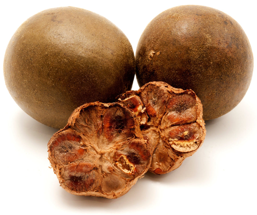 Image of 2 whole brown Luo Han Guo fruits and some brown pulp next to it