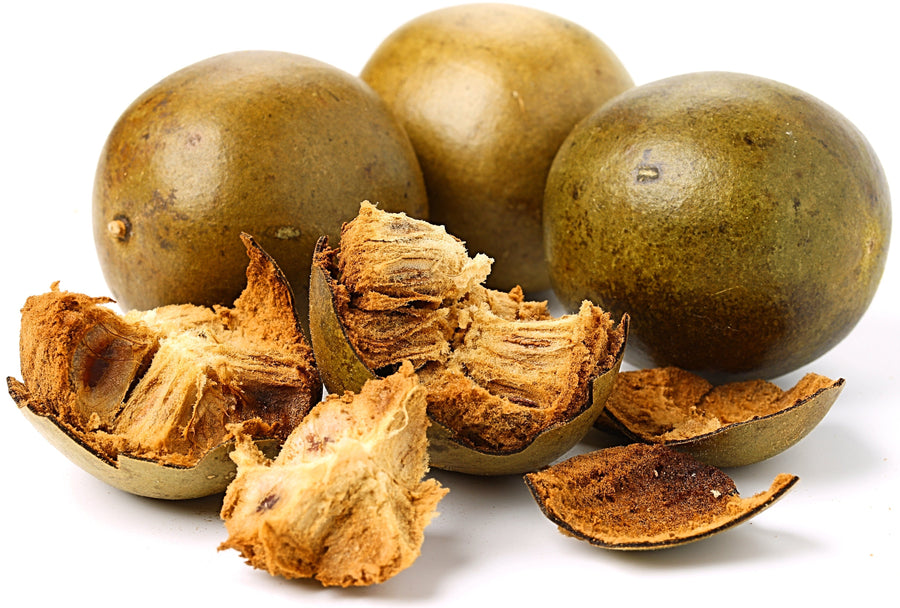 Image of 3 whole brown Luo Han Guo fruit and one is smashed