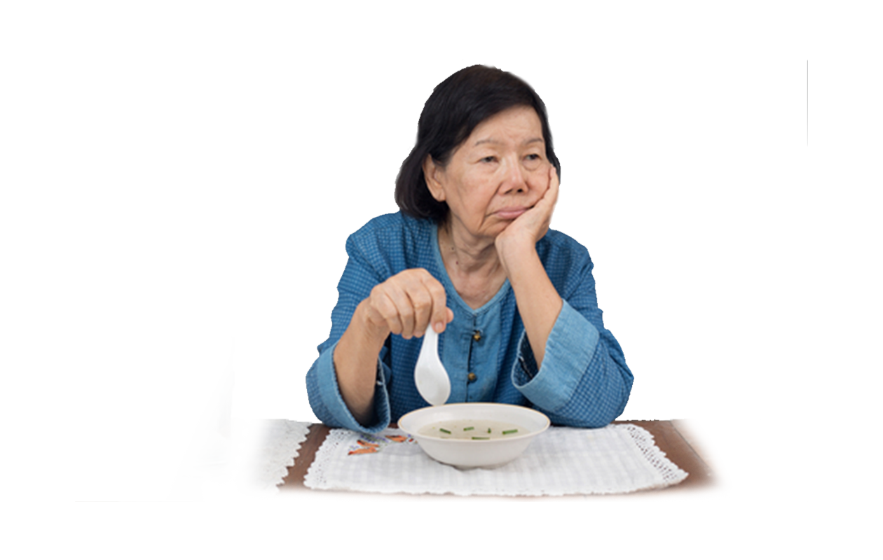 Image of woman at dinner table just dabbling with her Wan Ton soup, not interested in eating because her lack of appetite.