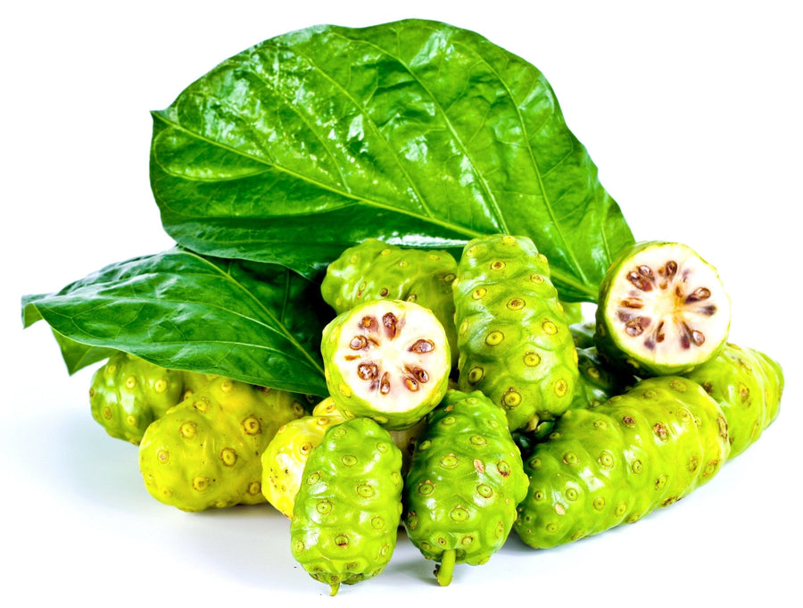 Image of a pile of fresh noni fruits some cut in half