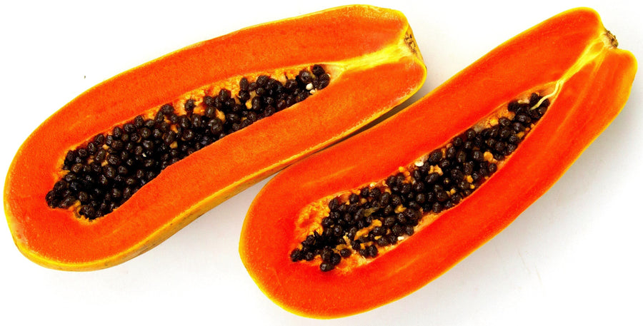 Image of a Papaya fruit sliced in half with black seeds on both slices