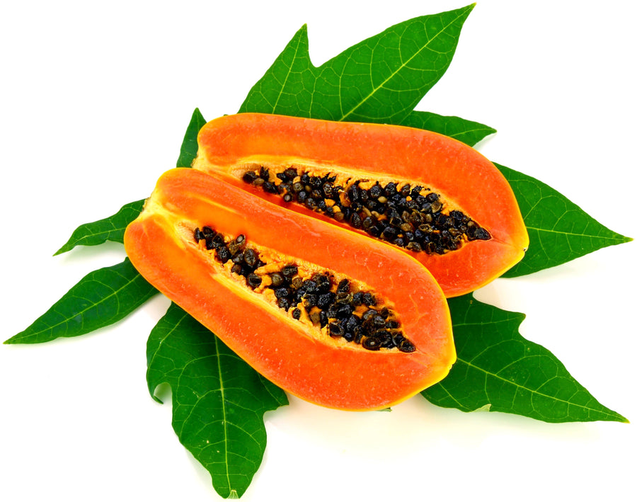 Image of halved Papaya on leaves with white background