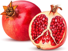 Image of a fresh Pomegranate and half of one showing its bright red seeds