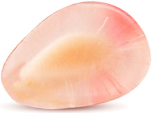Close up image of a pink pomegranate seed