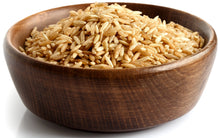 Brown Rice in wooden bowl piled together on white background