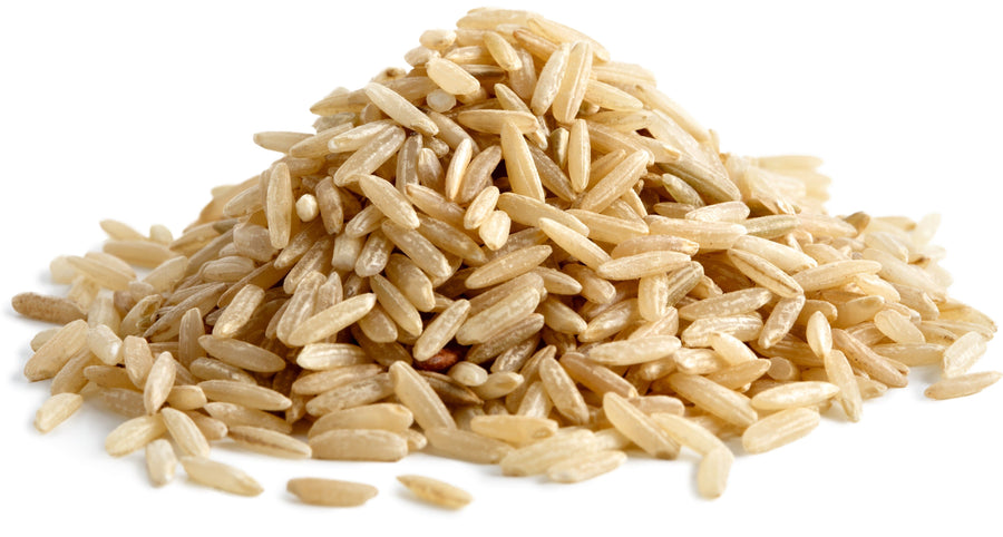 Brown Rice piled together on white background