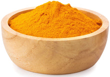 Image of bright orange Turmeric Root Powder inside a wooden bowl