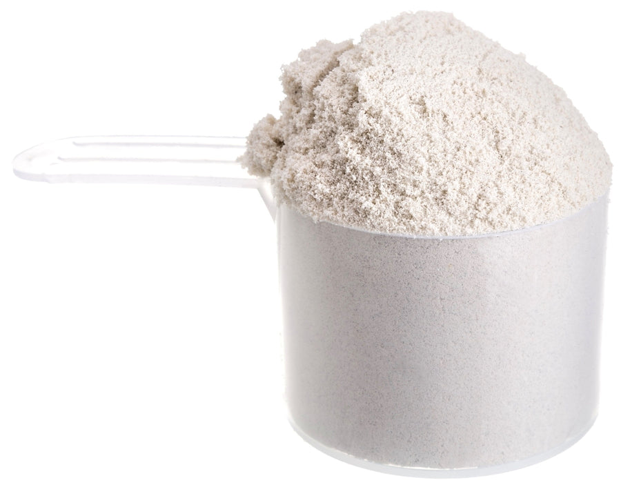 Image of Ultra Whey Protein Isolate powder in plastic measuring cup on white background
