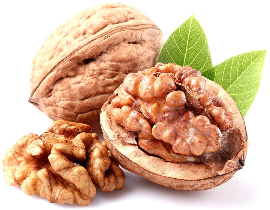 Image of Walnut with halved walnut kernel and whole walnut kernel in background.