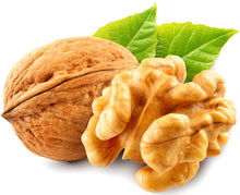 Closeup image of Walnut with walnut kernel behind it.