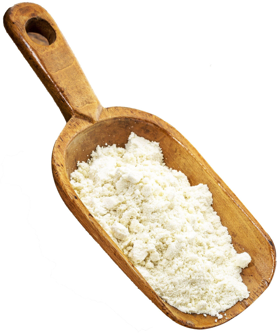 Whey Protein Concentrate - Grass-Fed powder on a wooden scoop