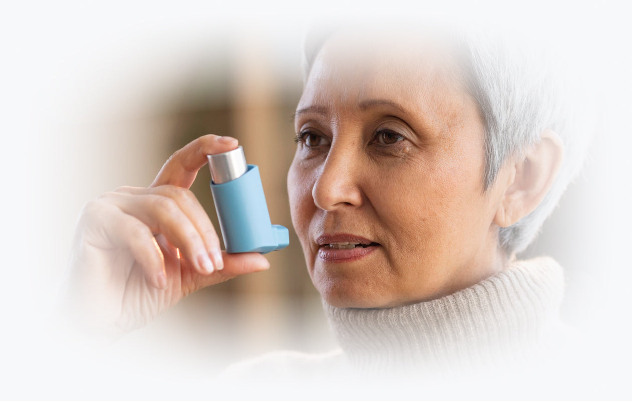 Image of woman with an asthma inhaler in her hand