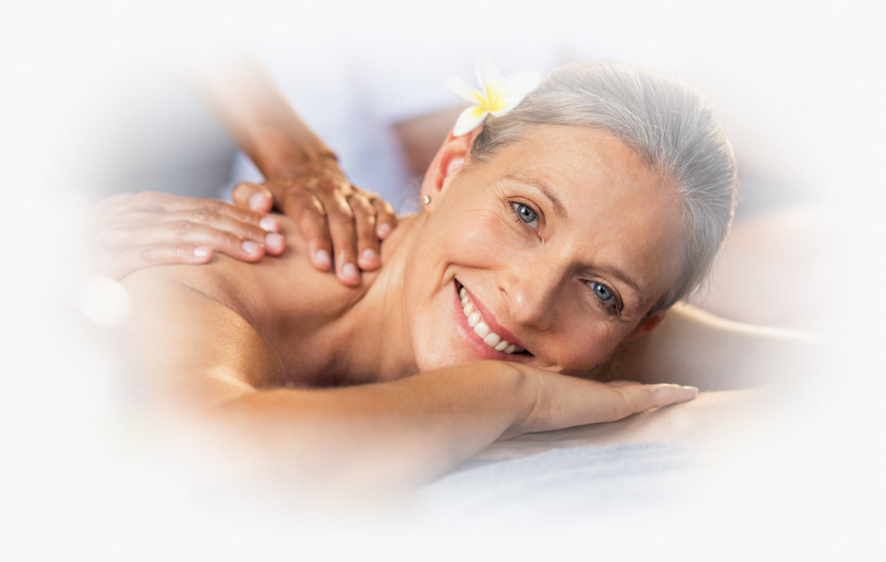 Image of woman smiling as she receives an upper back massage