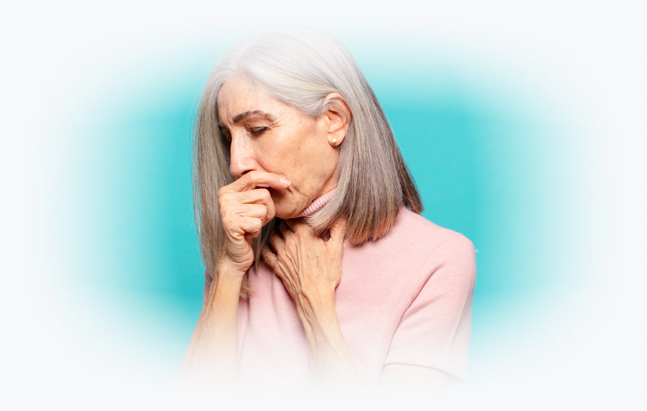 Image of woman coughing into hand.