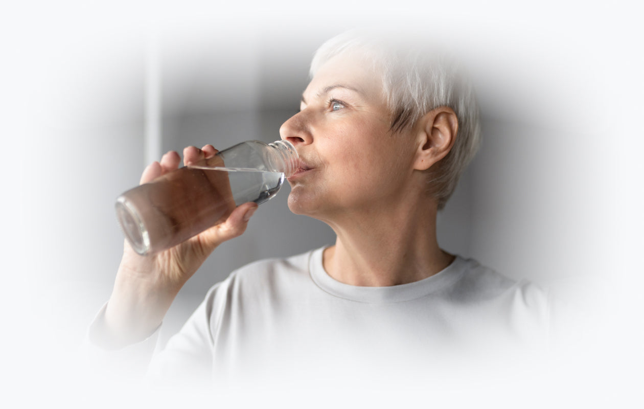 Woman drinking water signifying diuretics