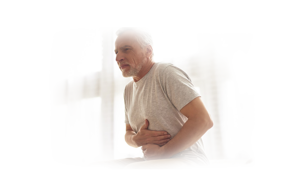 Image of man holding midsection because of gallbladder pain.